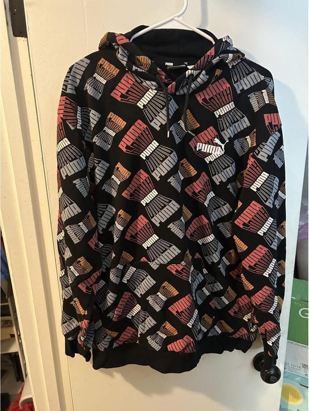 Puma hoodie with repeating Puma logo pattern in black, red, and gray